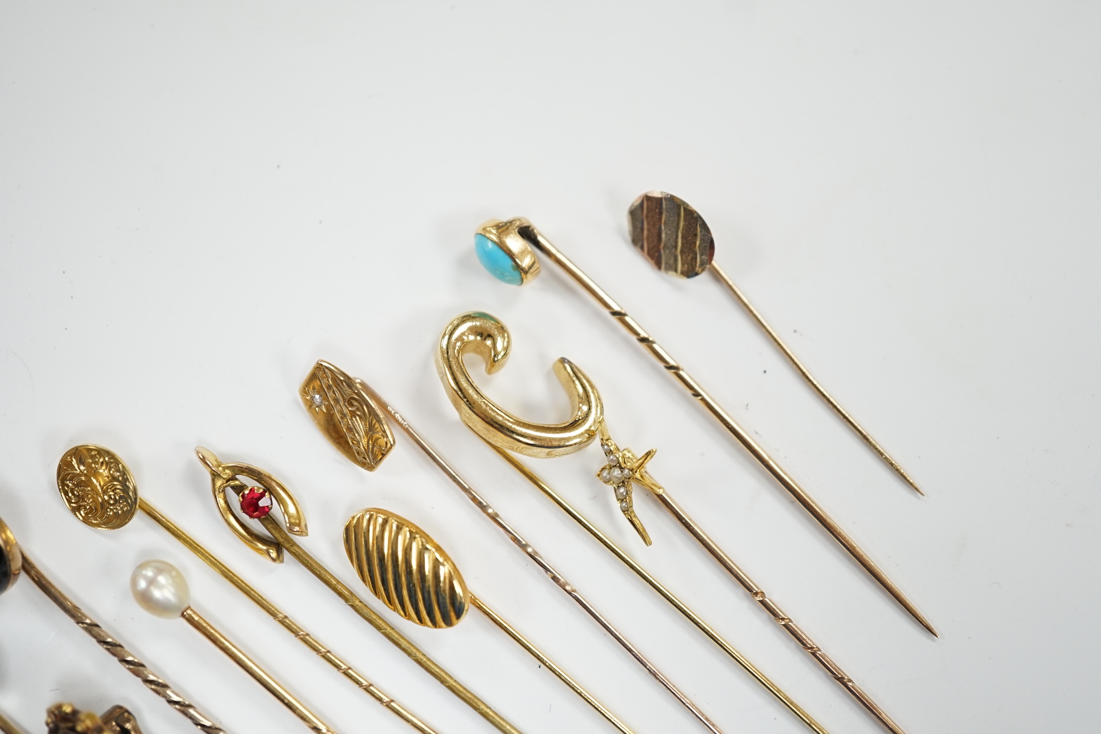 Fifteen assorted mainly early 20th century yellow metal and gem set stick pins, including diamond, seed pearl and banded agate, gross weight 23.1 grams.